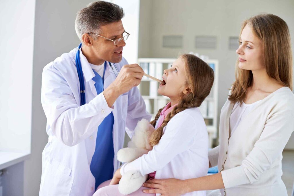 Adenoid surgery doubts parents discussing with ENT doctor during child throat examination in modern pediatric clinic