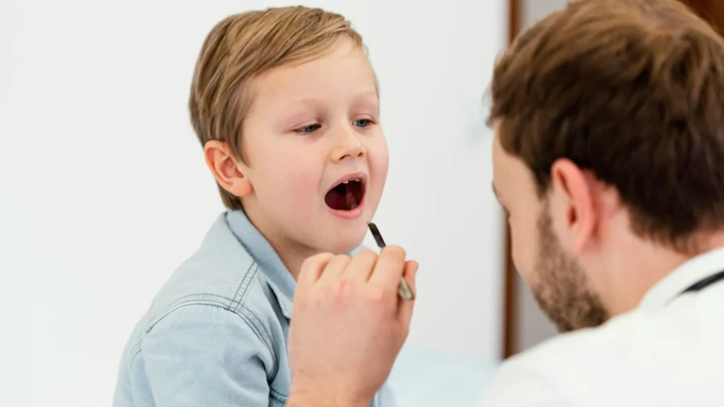 Adenoid treatment in Thrissur showing ENT specialist examining child with throat and breathing symptoms in clinic