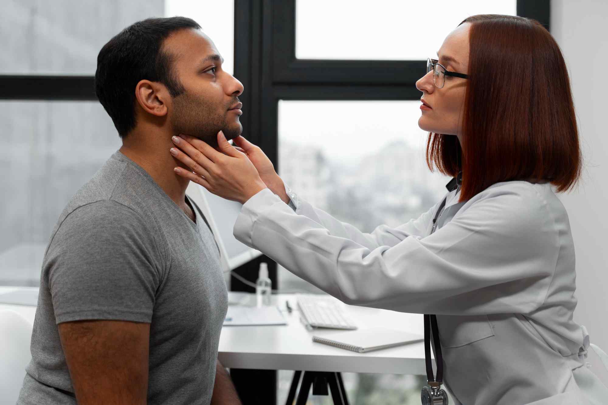 Voice and throat disorder treatment consultation with an ENT specialist examining a patient for voice changes, throat discomfort, and swallowing problems.